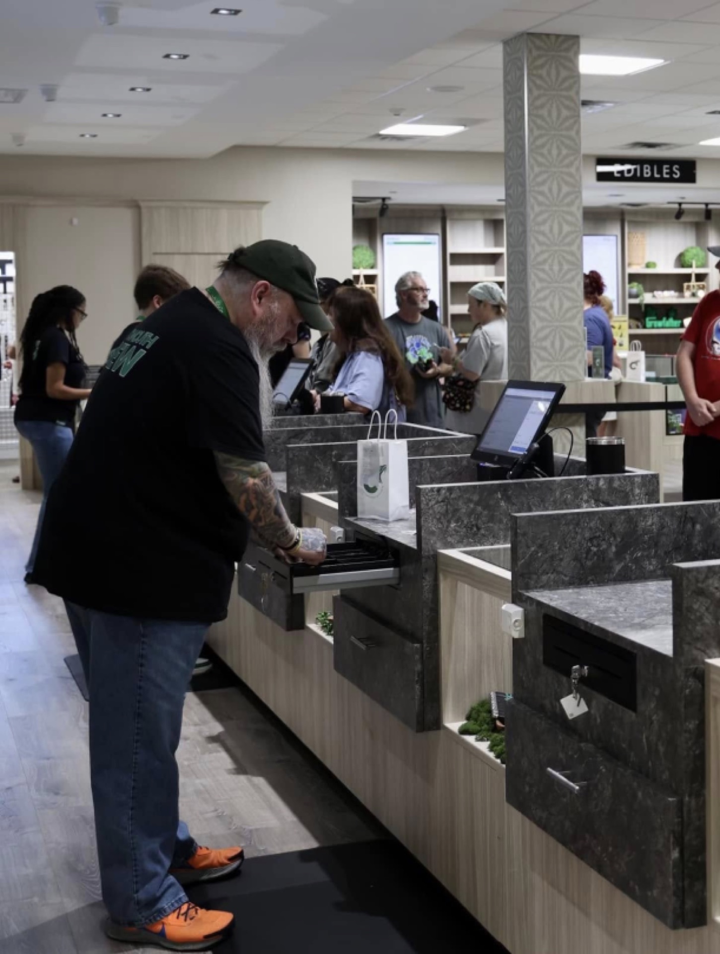 Budtenders helping customers at Cottonmouth Dispensary