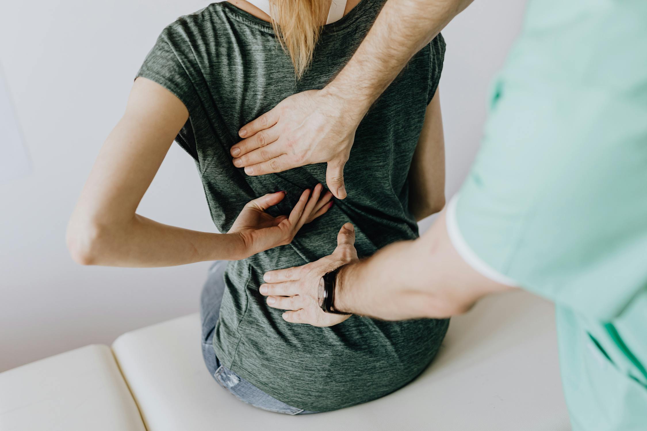 Person experiencing back pain and seeking relief