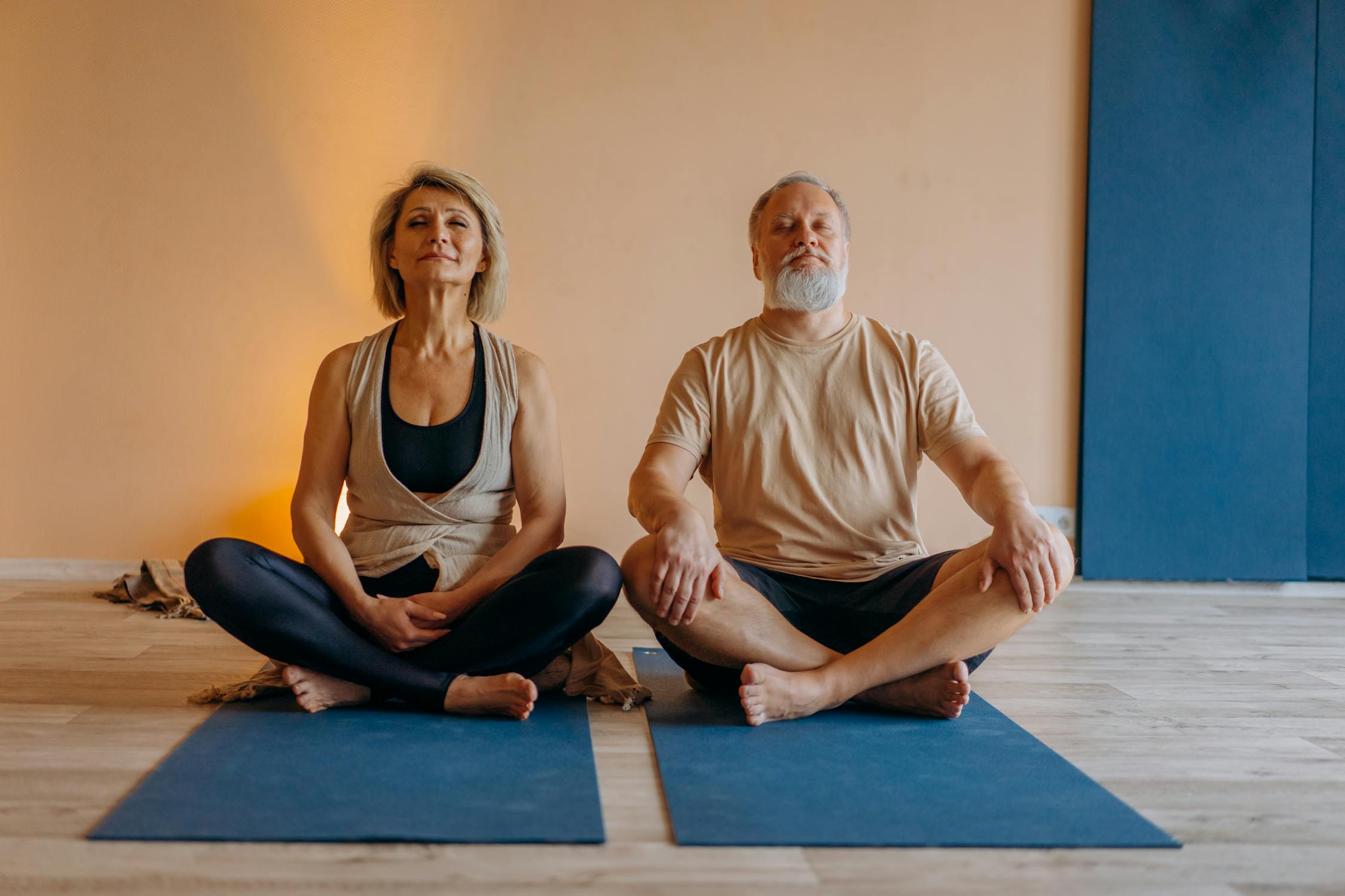 Active senior couple doing yoga for joint health